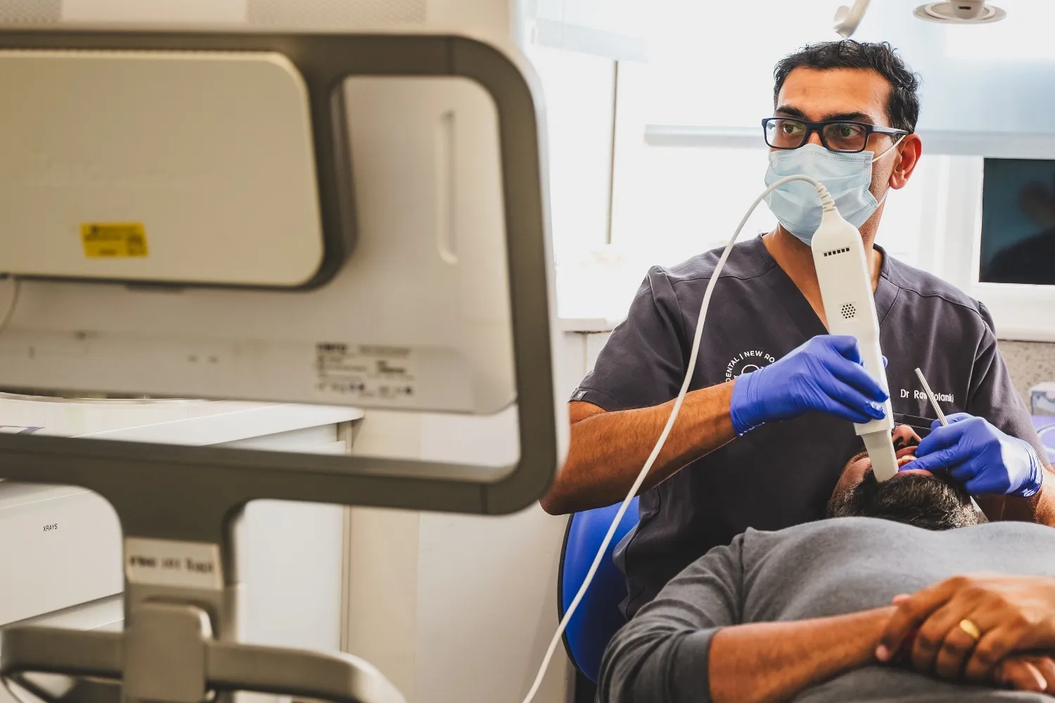 Dr Ravi Solanki carrying out a dental procedure at New Road Dental
